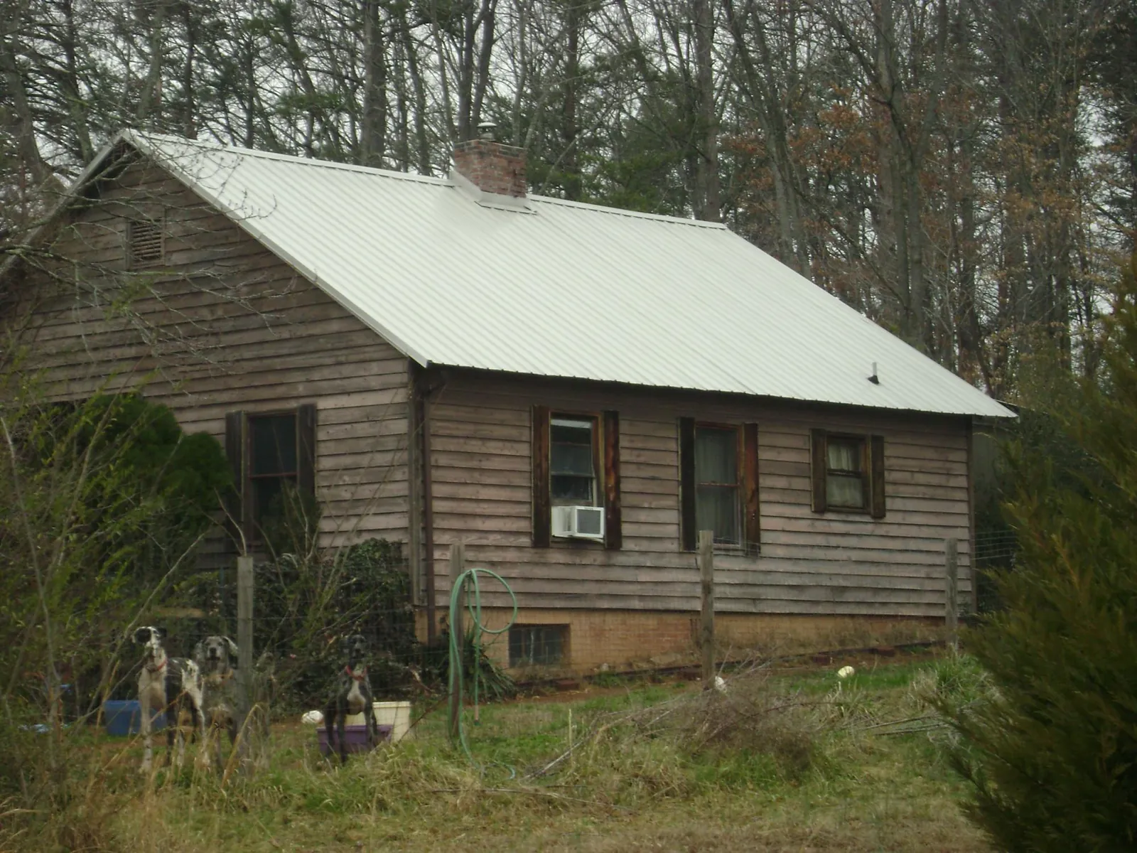 White metal roof on an old wood sided farmhouse, from a Asphalt Shingle Roof Repair job in Lula